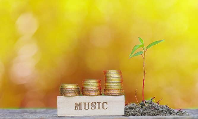 MUSIC WORD Golden coin stacked with wooden bar on shallow DOF