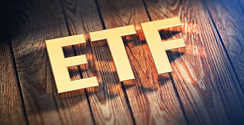 The acronym "ETF" is lined with gold letters on wooden planks.