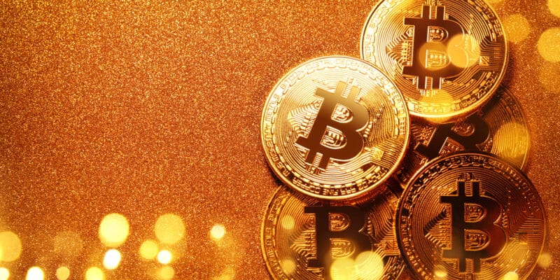 Bitcoin over gold glitter background. Business concept