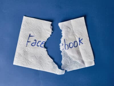 Facebook logo on torn paper napkin. Symbol of Facebook shutdown, data leaks, name change