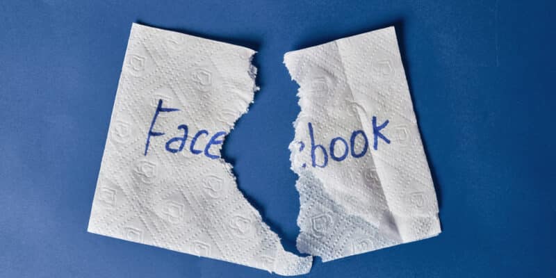 Facebook logo on torn paper napkin. Symbol of Facebook shutdown, data leaks, name change