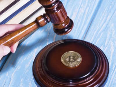judge's hammer and bitcoin gold coin. Digital currency