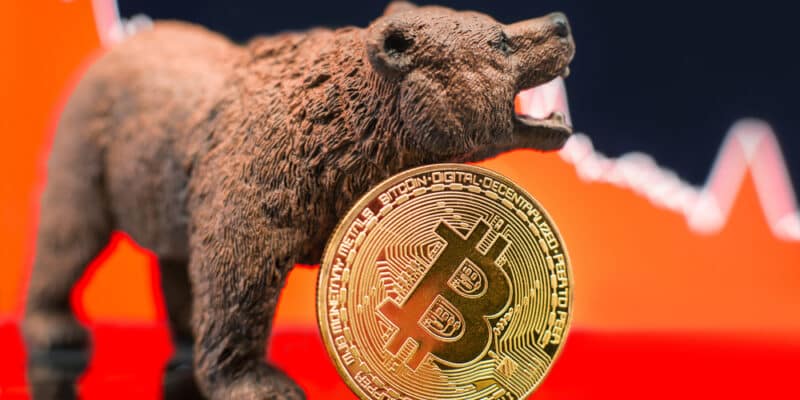 Bitcoin with a red chart drop. Price crash and bear market trend concept.