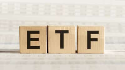 ETF abbreviation on wooden cubes on a light background.