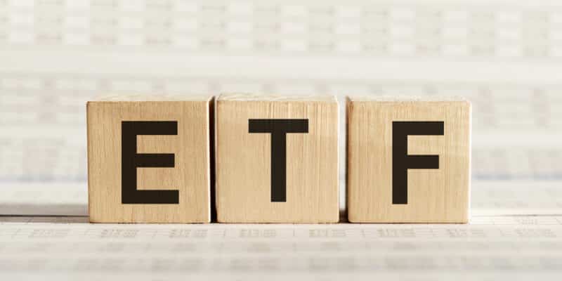 ETF abbreviation on wooden cubes on a light background.