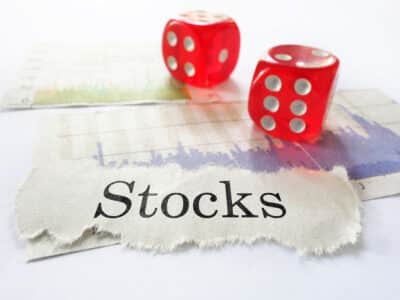 Stocks newspaper headline with stock market graphs and dice