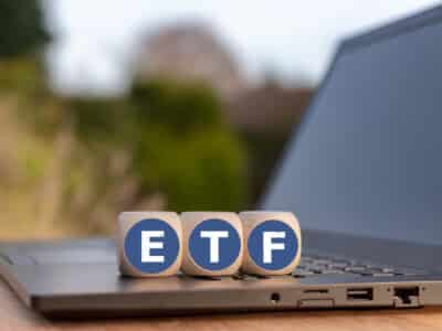 Cubes placed on a Notebook with the letters "ETF" which stands for "Exchange traded funds".