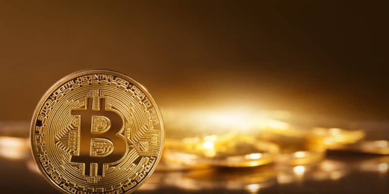Gold bitcoins on a yellow background