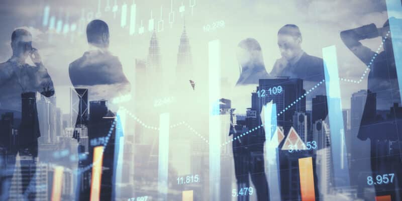 Teamwork and market concept. Group of young businesspeople working together on bright city background with glowing forex graph. Double exposure